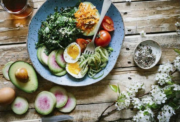 Colorful salad bowl with grains, vegetables, and seeds